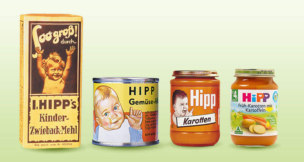 Vier verpakkingen met babyvoeding met verschillende ontwerpen en etiketten, die de evolutie van verpakkingen door de tijd heen laten zien.